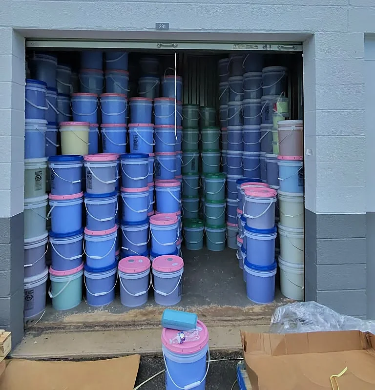 JD Soap Supply storage unit stacked floor to ceiling with 5-gallon buckets